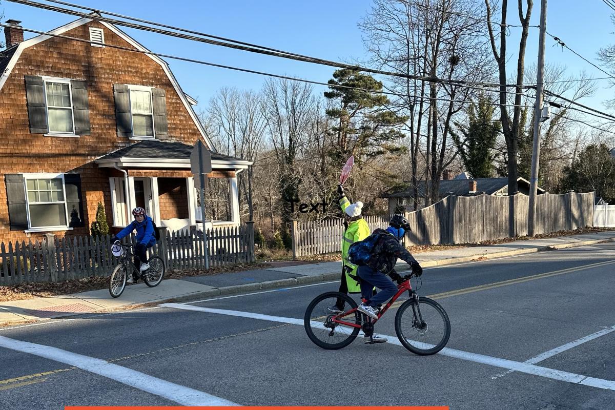Still Biking in December to Gates, safely with the help of Crossing Guard Downey